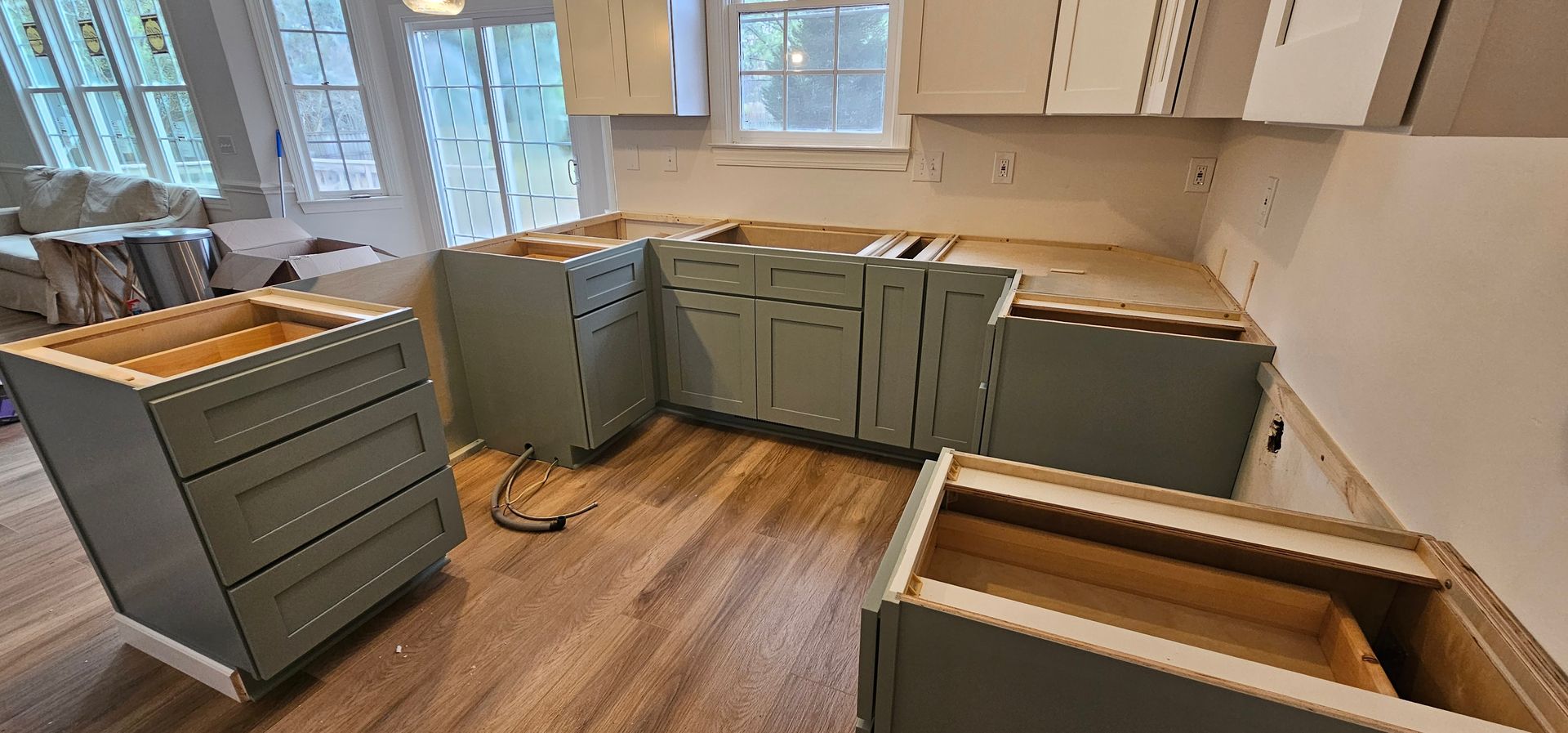 A kitchen under construction with a lot of cabinets and drawers.