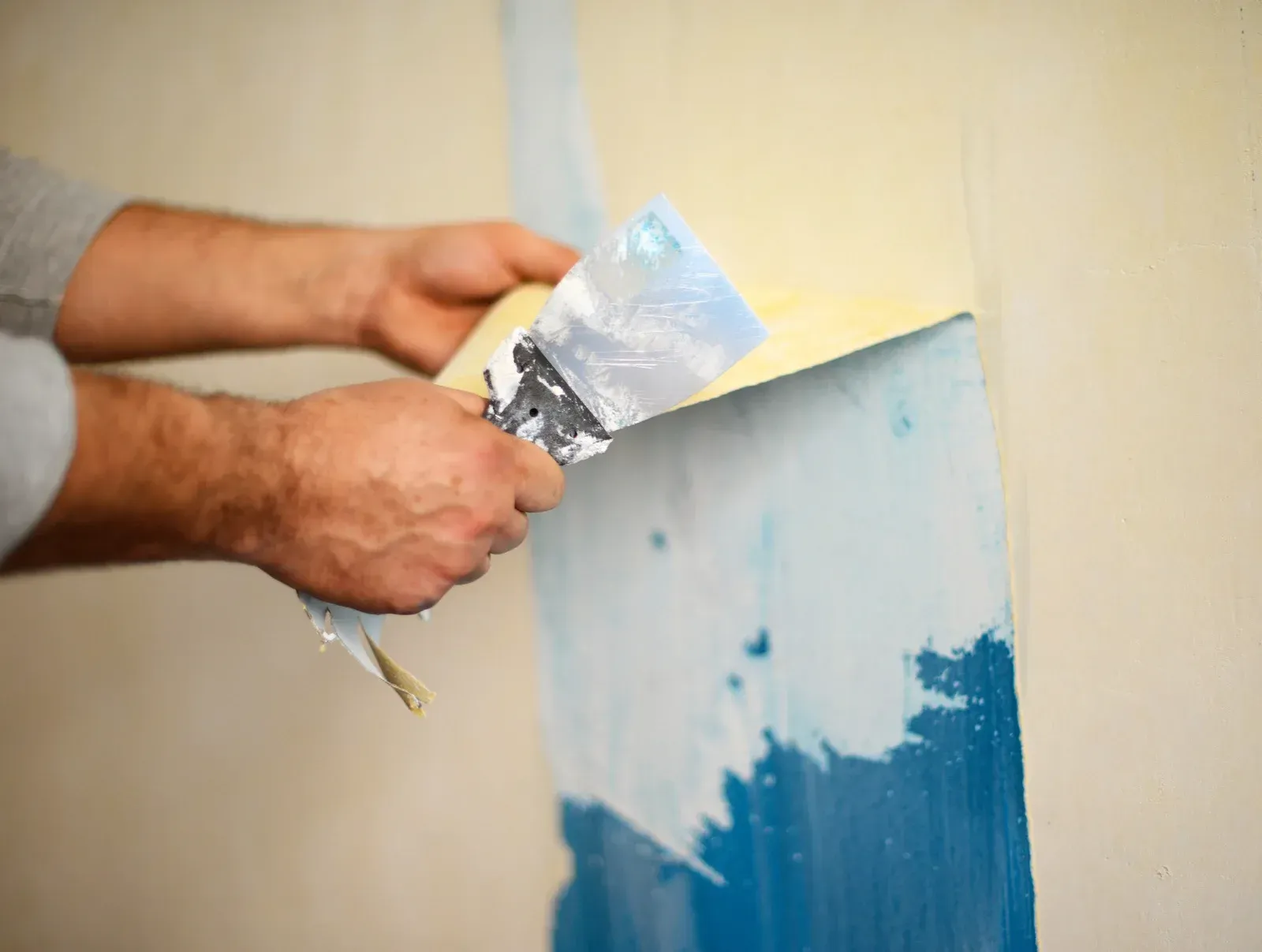 A person is painting a ceiling in a room.