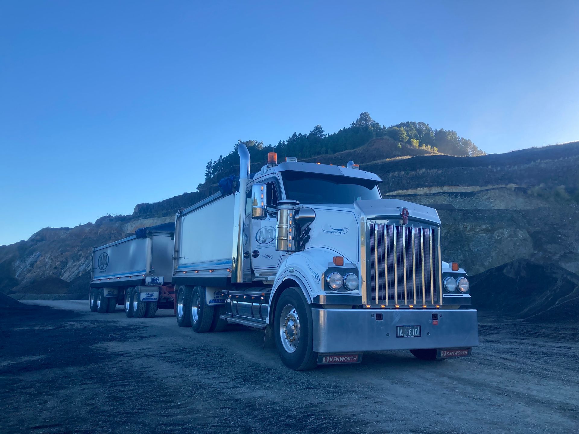 A Large Dump Truck is Parked on the Side of a Dirt Road  — Andrew Johnston Haulage In Ewingsdale, NSW