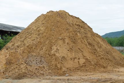 A Large Pile Of Dirt Sits In Front Of A Building - Top-Quality Landscape Supplies in Byron Bay, NSW