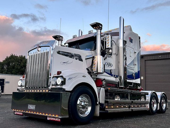 A Large Semi Truck is Parked in Front of a Garage — Andrew Johnston Haulage In Suffolk, NSW