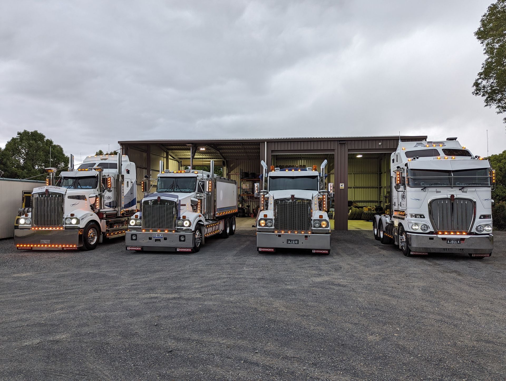 A Row of Semi Trucks Parked in Front of a Building — Andrew Johnston Haulage In Mullumbimby, NSW