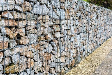 A Stone Wall With A Metal Fence Surrounding It - Top-Quality Landscape Supplies in Byron Bay, NSW