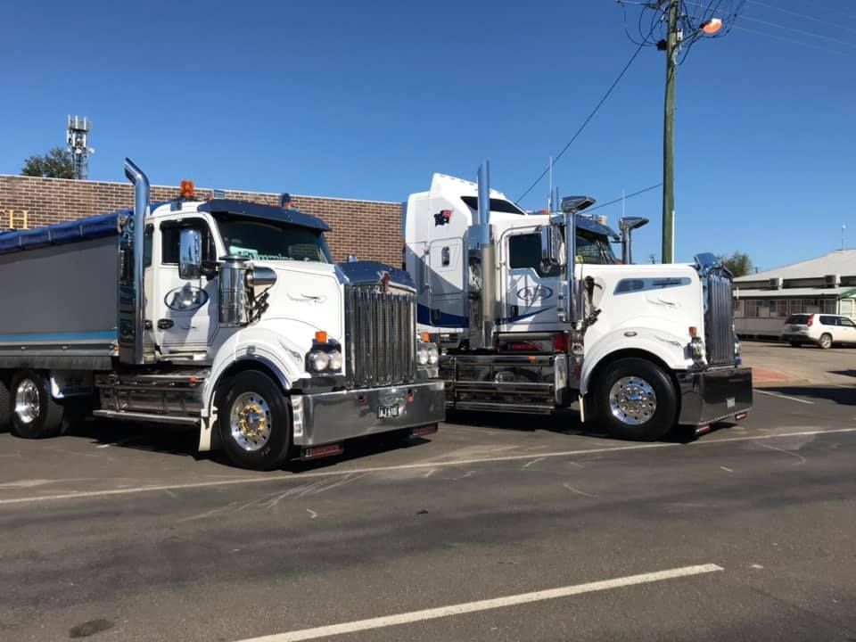 Two Semi Trucks Are Parked Next to Each Other on the Side of the Road — Andrew Johnston Haulage In Mullumbimby, NSW