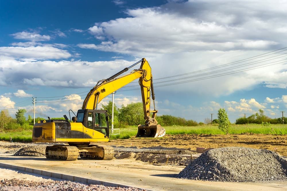 A Yellow Excavator Is Parked On A Construction Site - Order Your Bulk Landscape Supplies in Tweed Heads, NSW