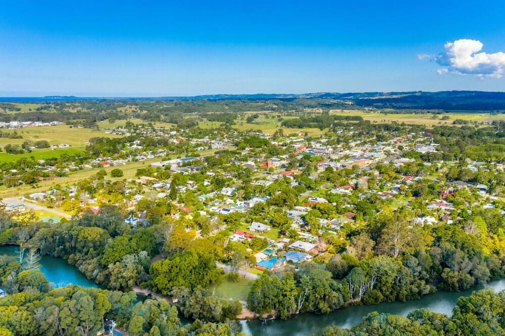 An Aerial View of a Small Town Surrounded by Trees and a River — Andrew Johnston Haulage In Mullumbimby, NSW