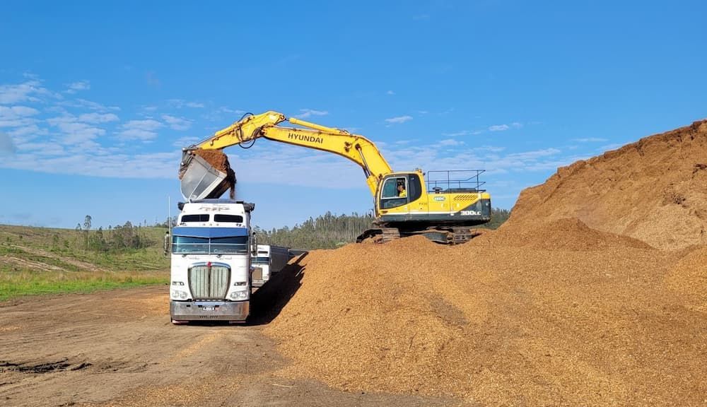 A Truck is being Loaded with Dirt by Excavator  — Andrew Johnston Haulage In Ewingsdale, NSW