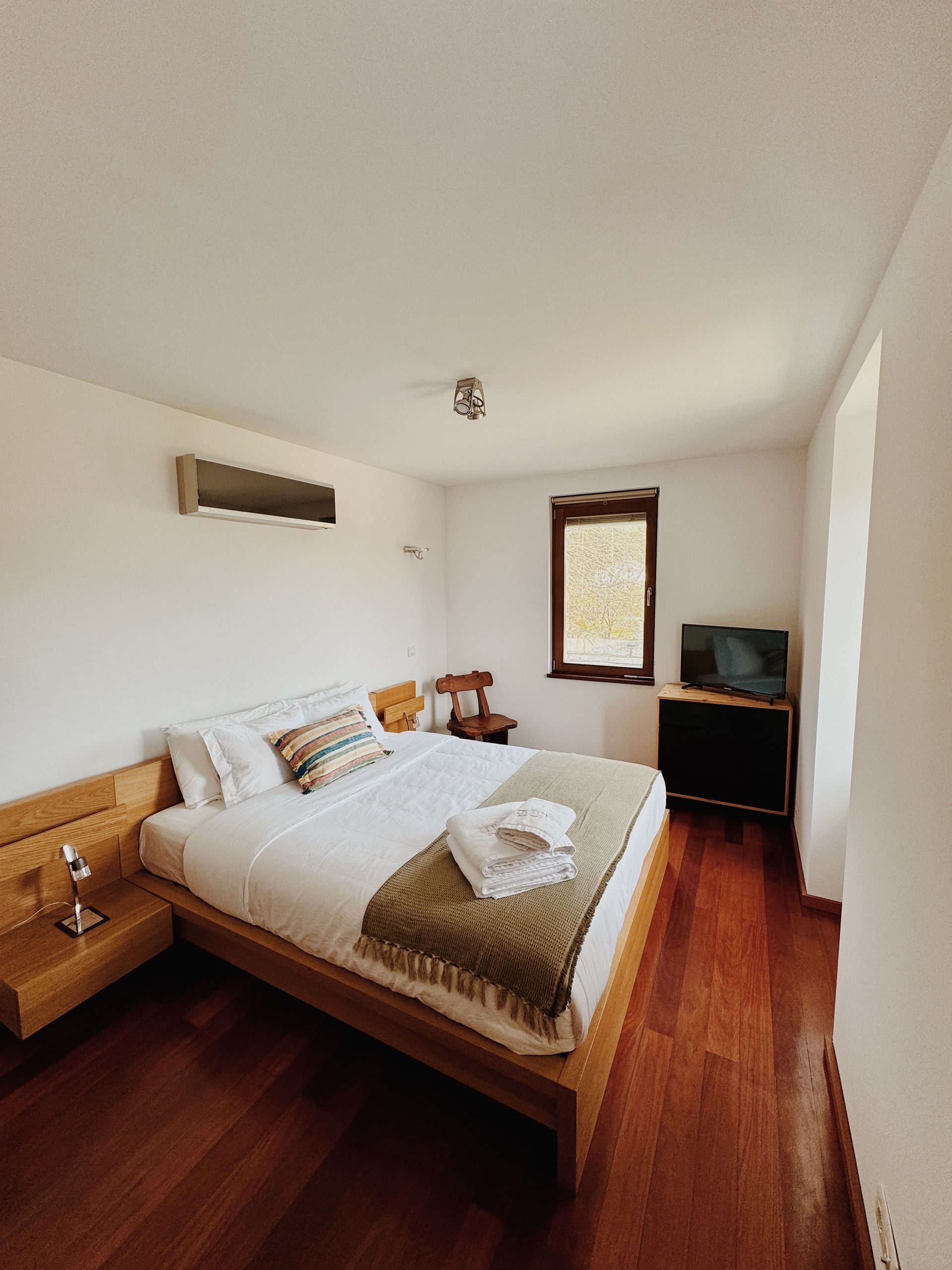Um quarto com uma cama grande e uma televisão