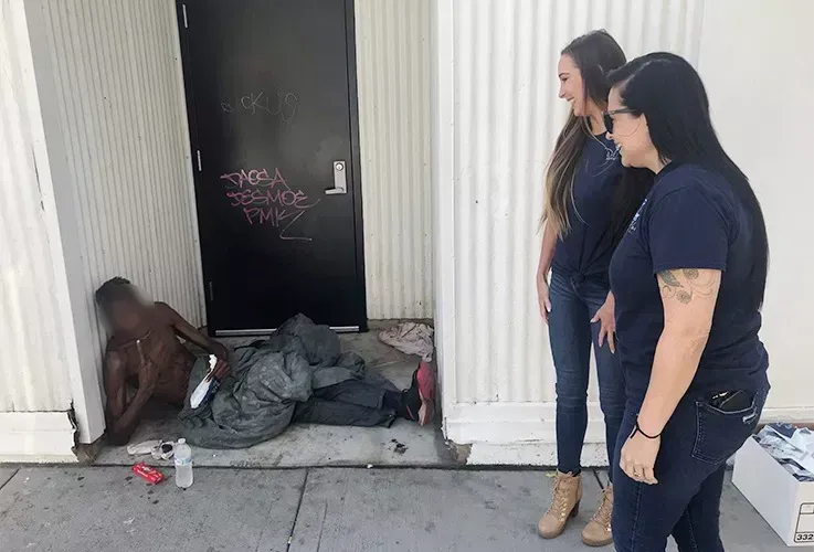 Del Mar Dental staff helping a homeless man on the street.