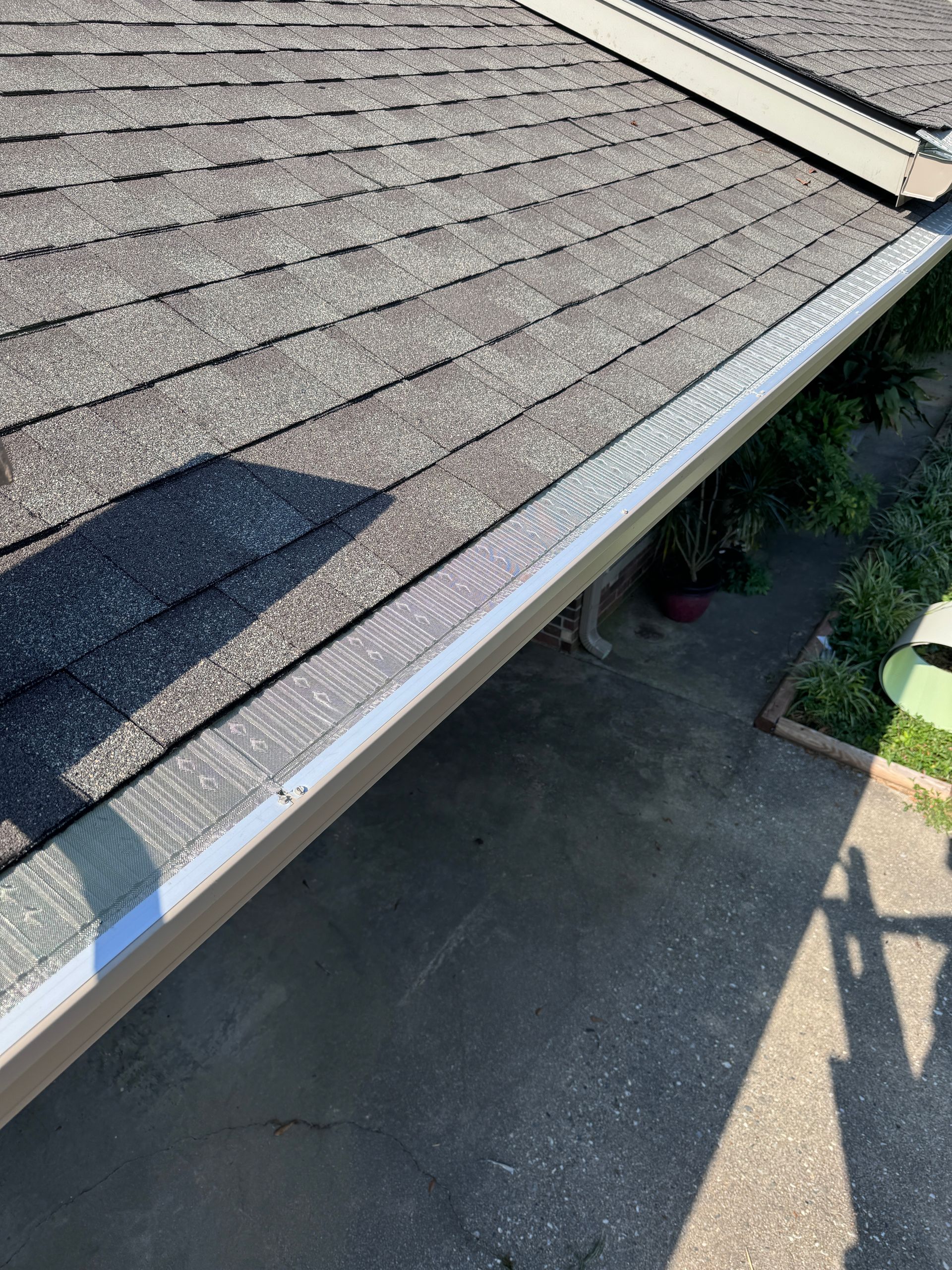 A close up of a roof with a gutter on it.