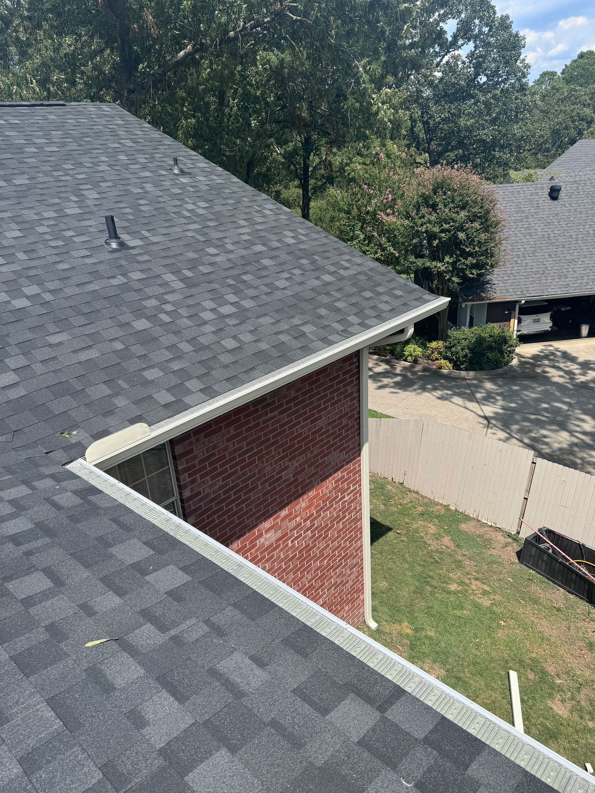 An aerial view of a roof of a brick house.