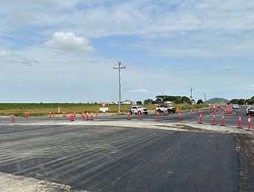 A Lot Of Traffic Cones Are On The Side Of A Road — Elite Bitumen & Asphalt In Mackay, QLD