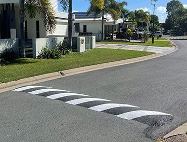 A Black And White Striped Curb On The Side Of A Road — Elite Bitumen & Asphalt In Mackay, QLD