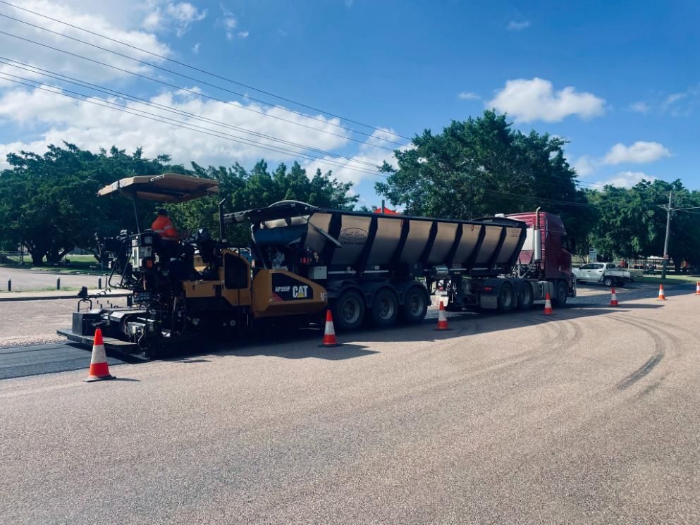 A Truck With A Dumpster Attached To It Is Being Loaded With Asphalt — Elite Bitumen & Asphalt In Mackay, QLD