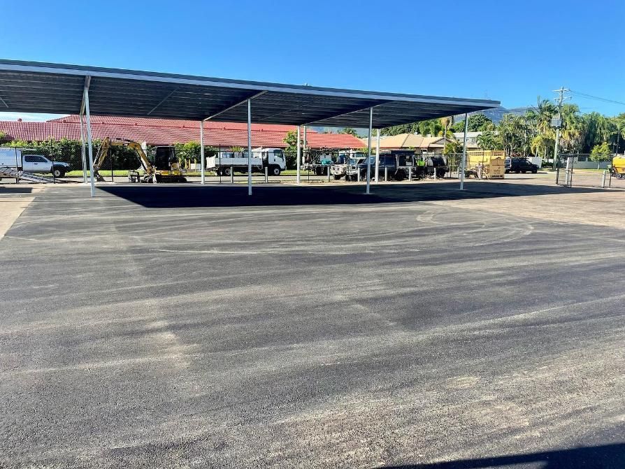 A Parking Lot With A Lot Of Cars Parked Under A Canopy — Elite Bitumen & Asphalt In Airlie Beach, QLD