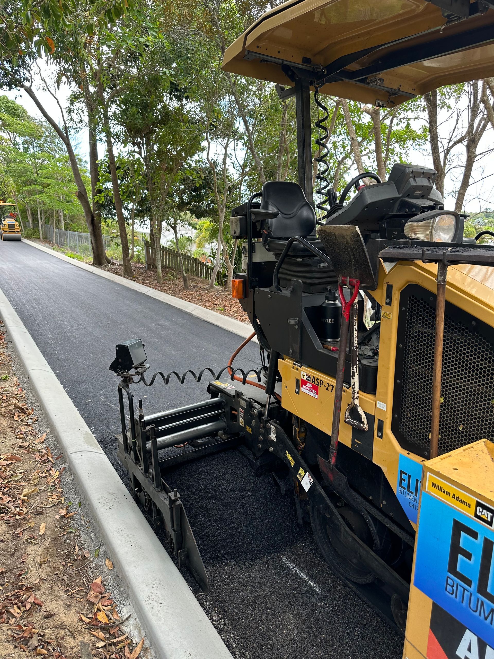 A Yellow Machine Is On An Asphalt Pathway — Elite Bitumen & Asphalt In Mackay, QLD