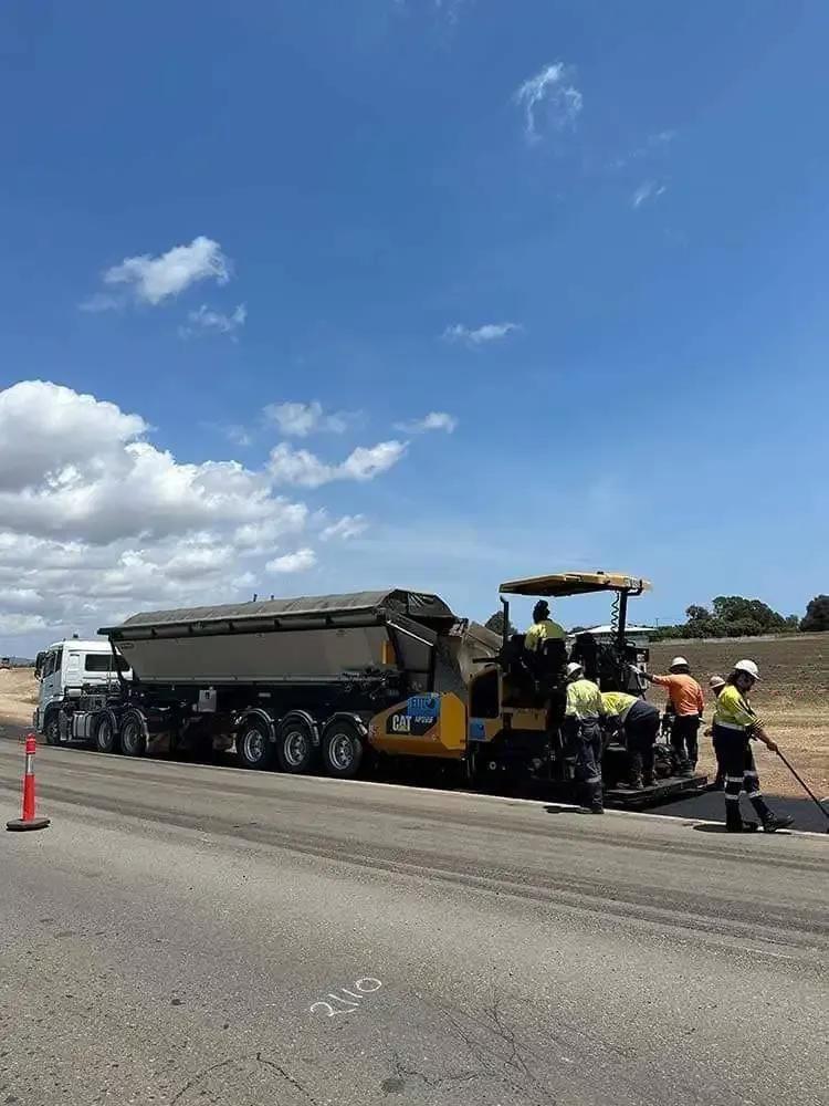 A Group Of Construction Workers Are Working On A Road — Elite Bitumen & Asphalt In Mackay, QLD