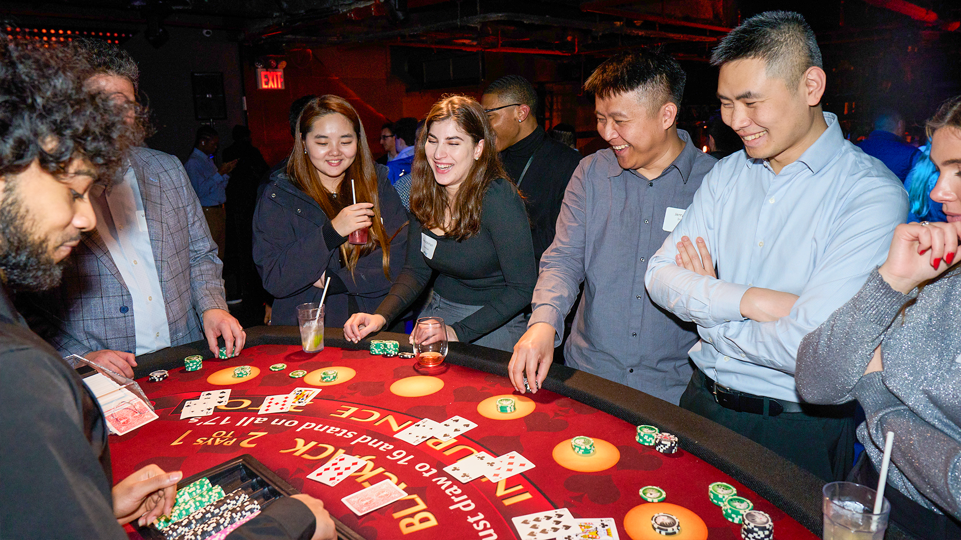 Guests smiling around a blackjack table