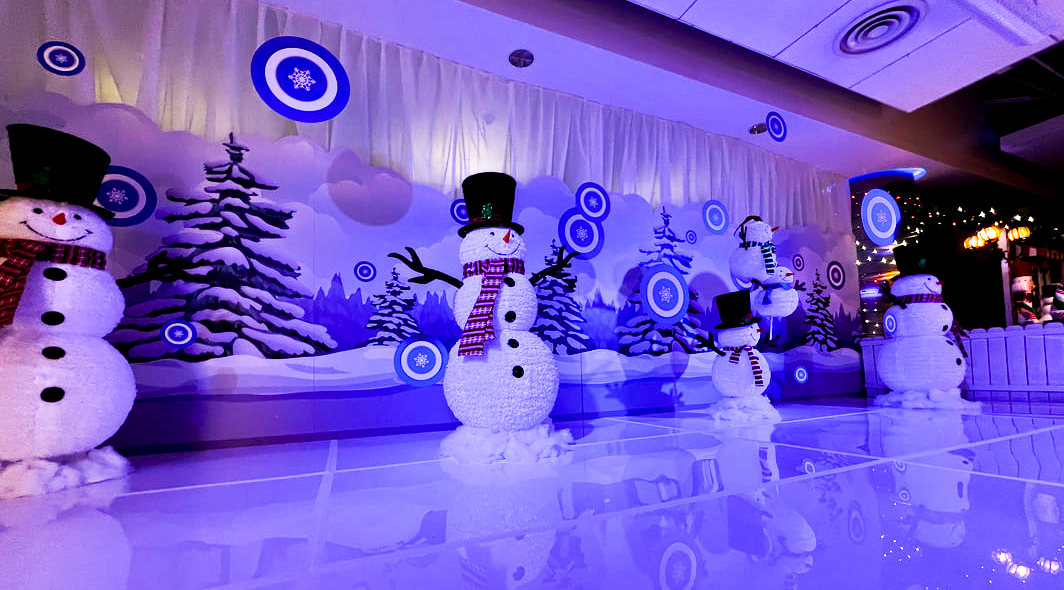 Holiday decor setup with snowmen and trees