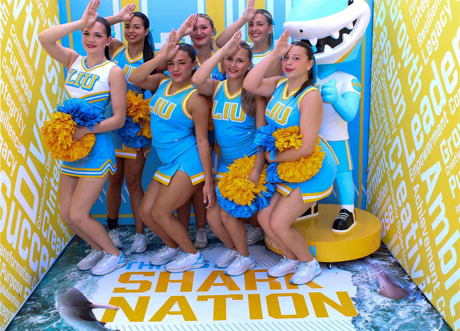 College cheerleaders posing in a custom photo booth enclosure