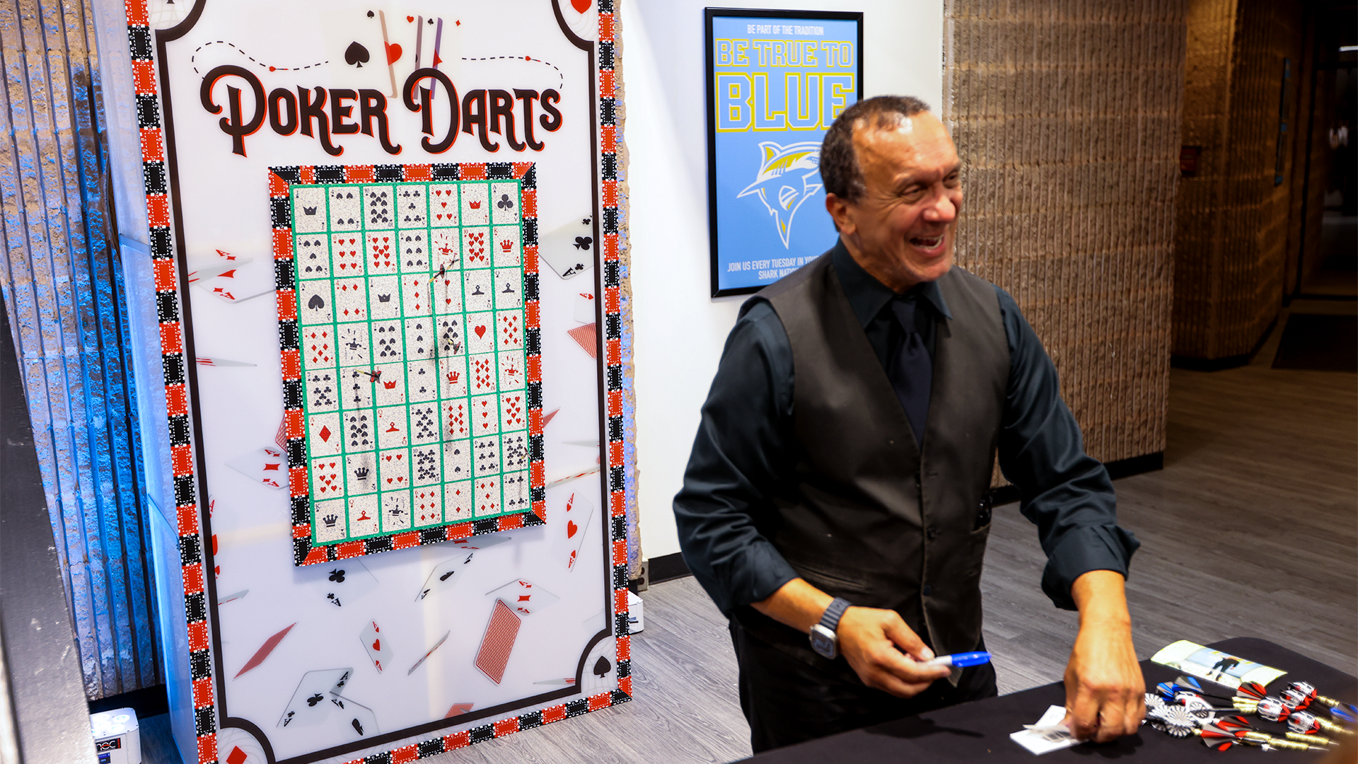 A man standing in front of a dart board