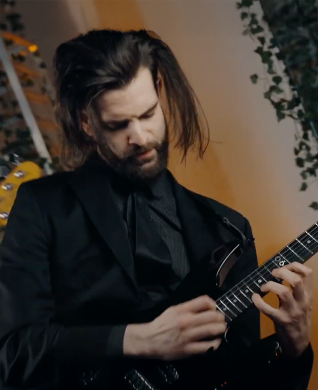 A man holding an electric guitar