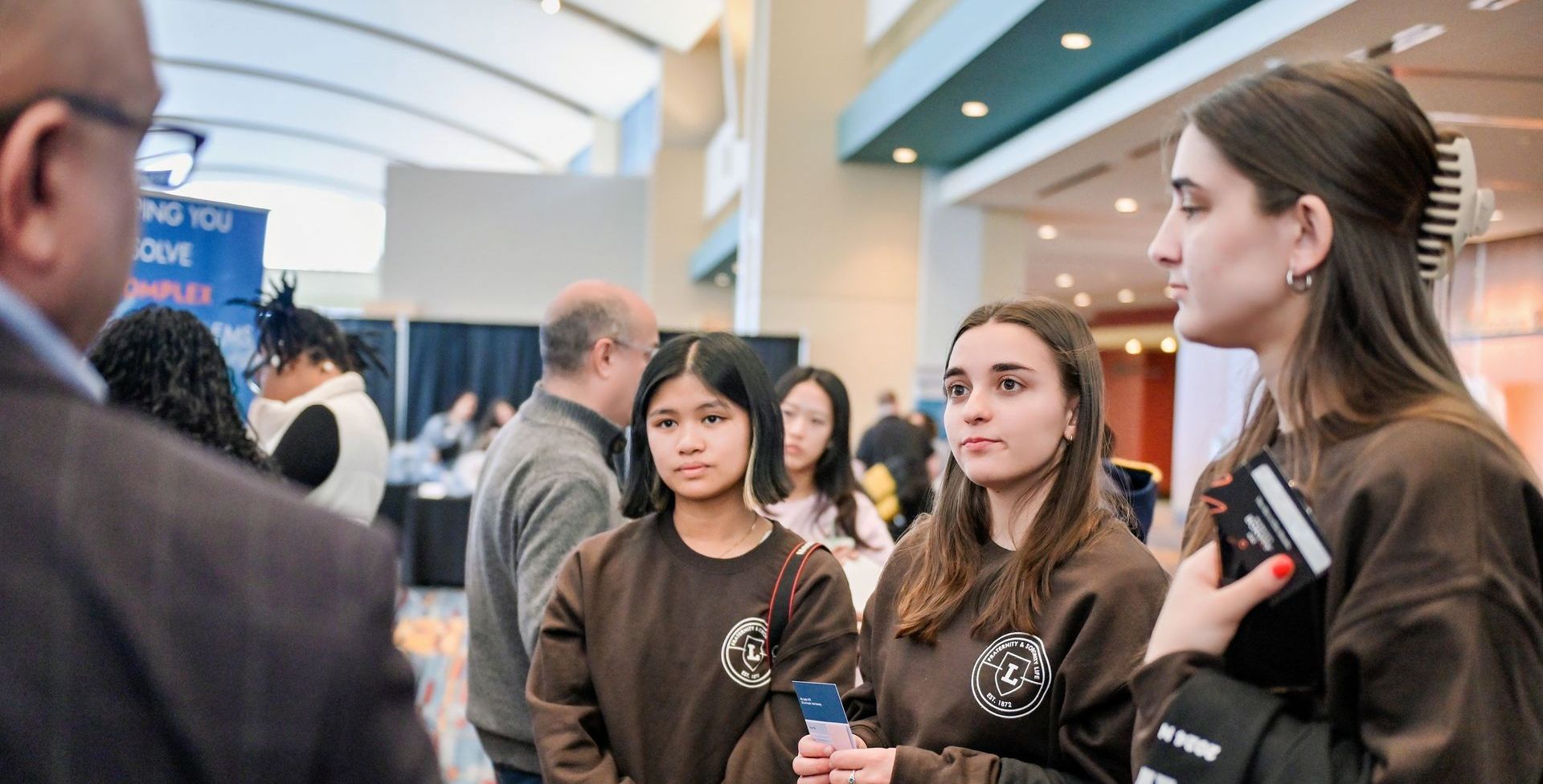 Students networking at a trade show