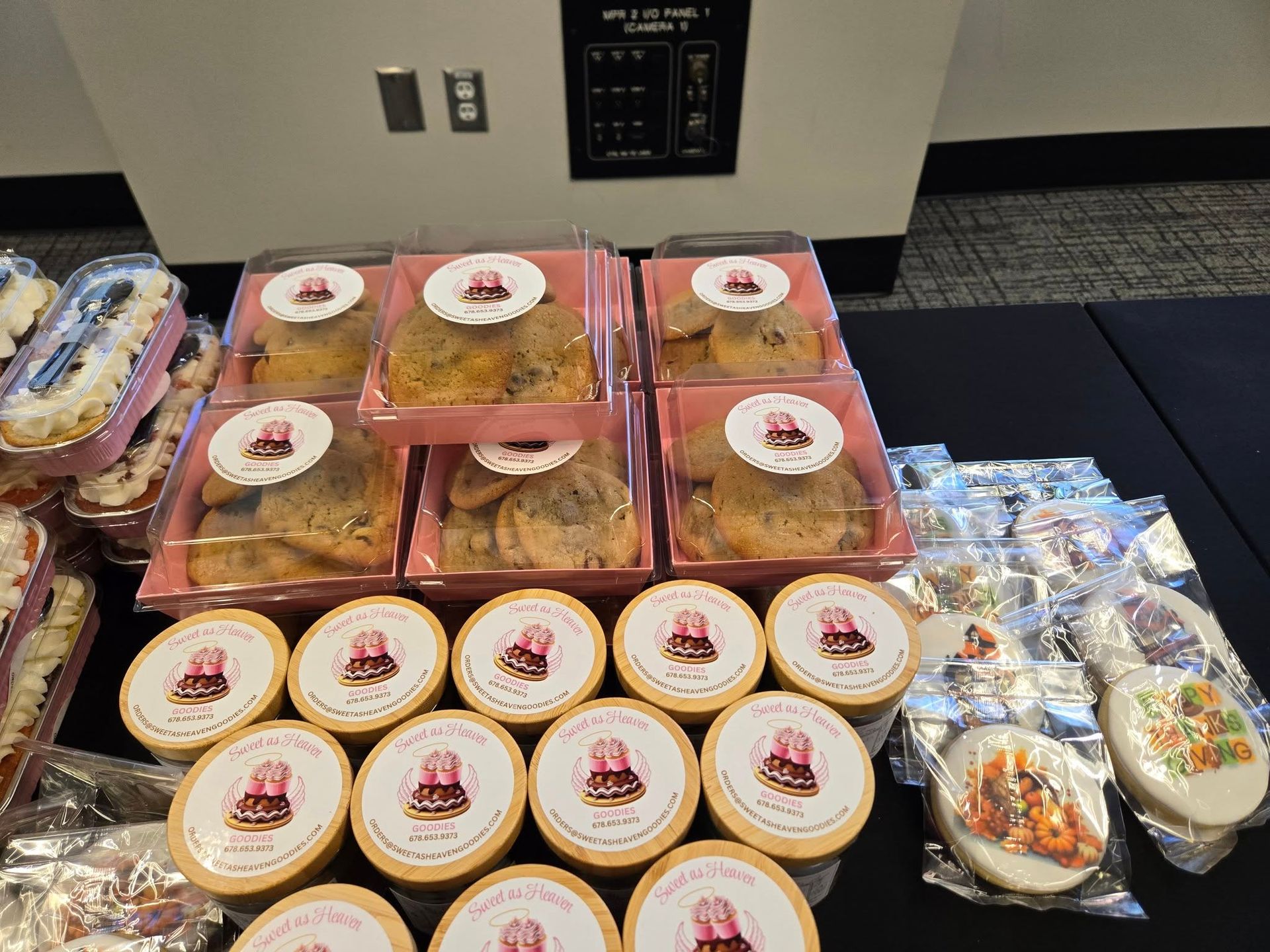 Assorted packaged pastries and desserts arranged on a table at a buffet or catering setup