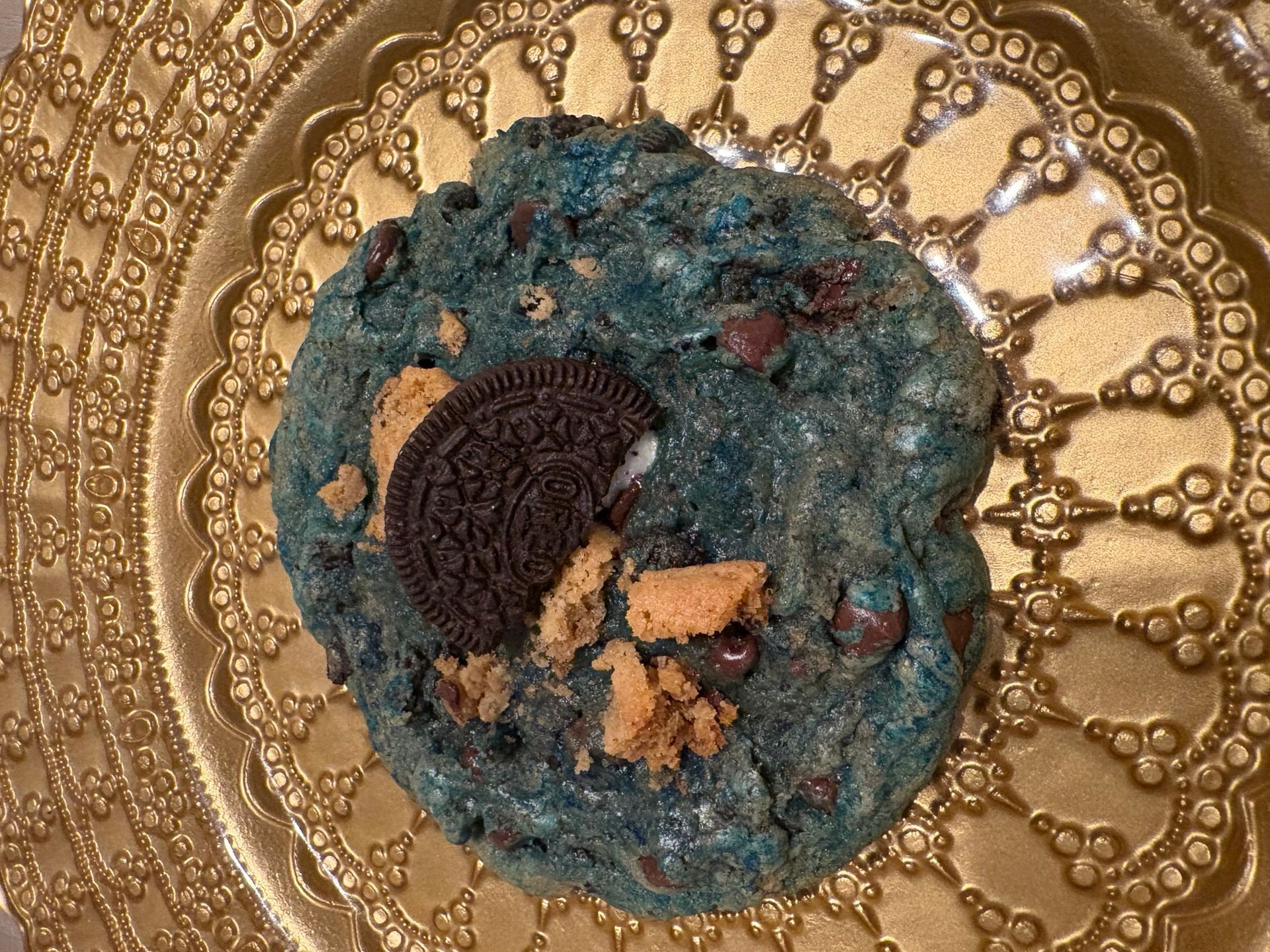 Blue textured dessert on an ornate gold plate