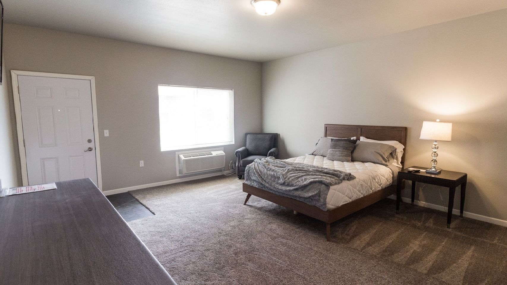 An artist 's impression of a bedroom with a large bed and a walk in closet.