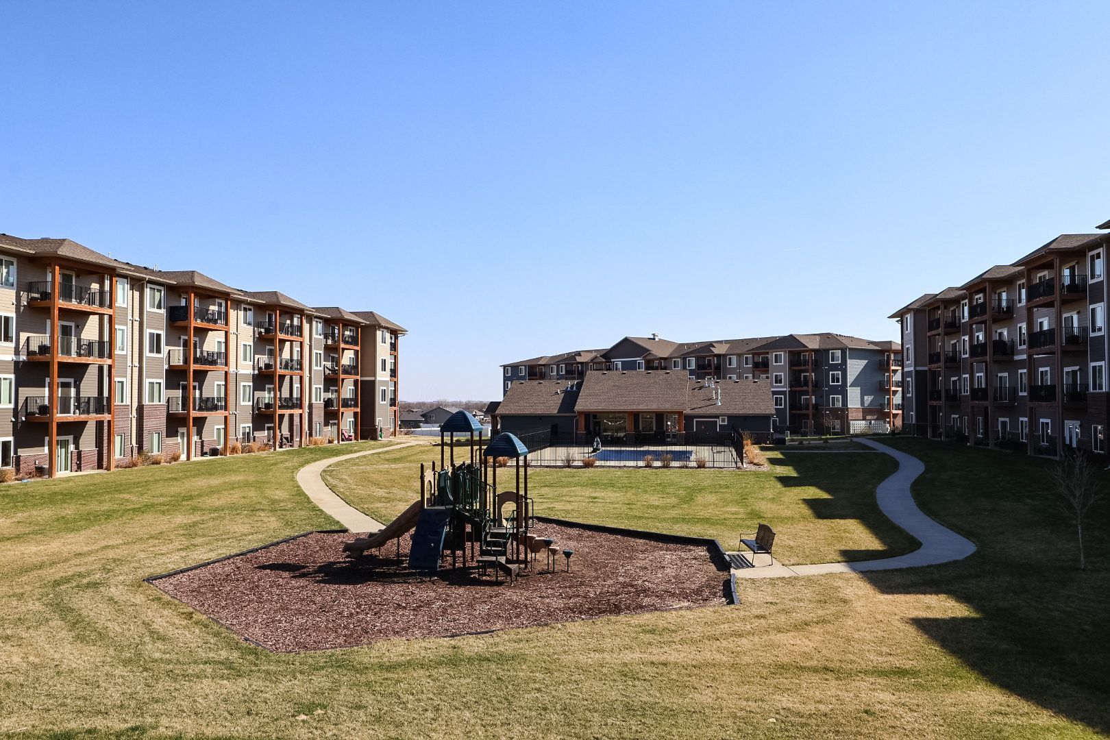 A kitchen with stainless steel appliances and wooden cabinets