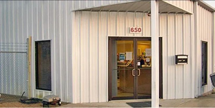 White metal building with a glass double door entrance at number 650.