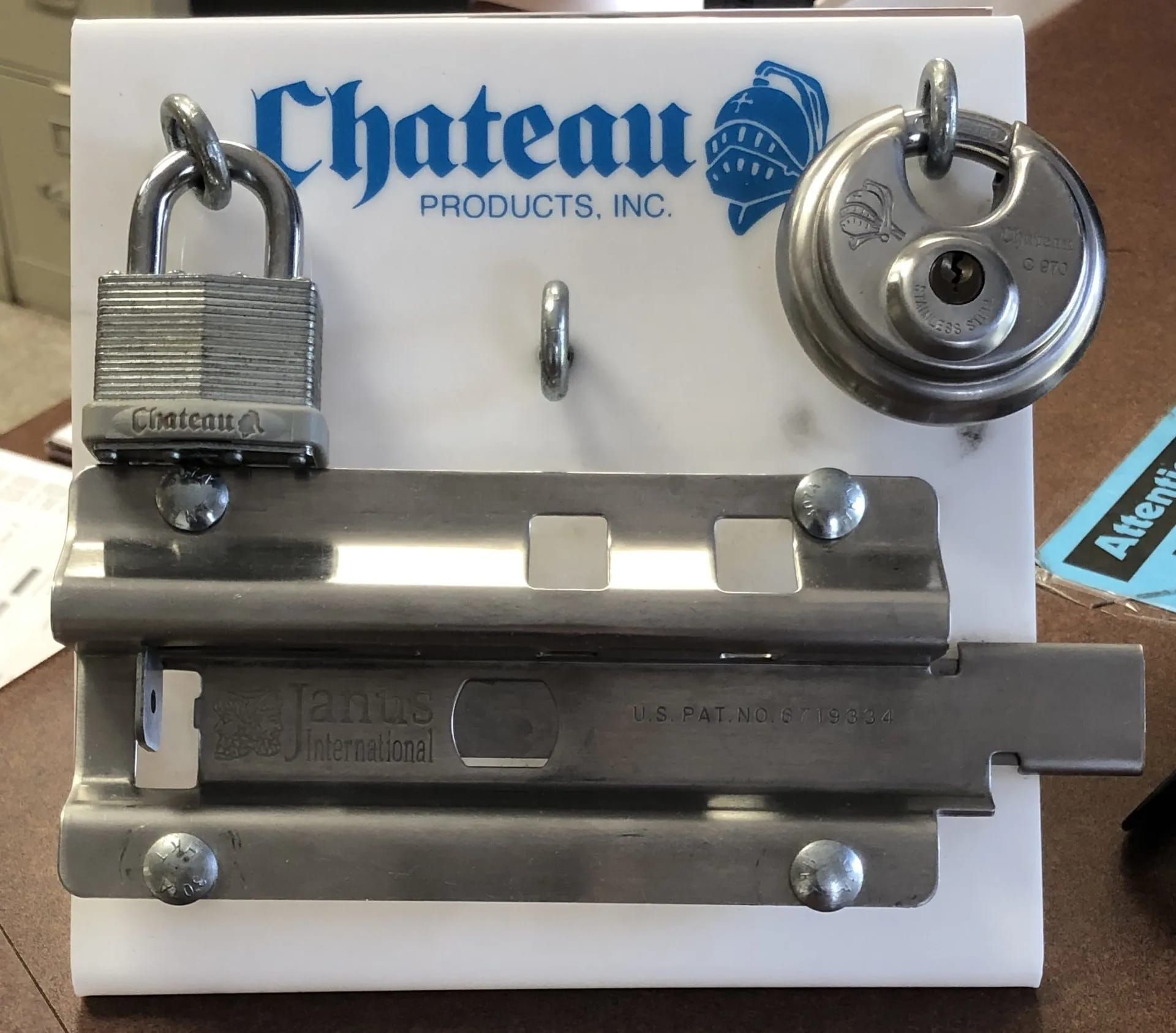 White board with Chateau lock and bolt hardware for demonstration.