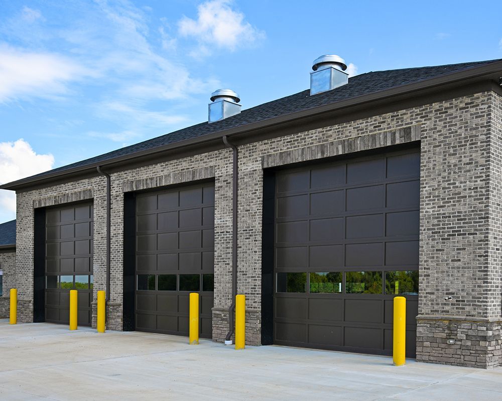 A row of garage doors on a brick building