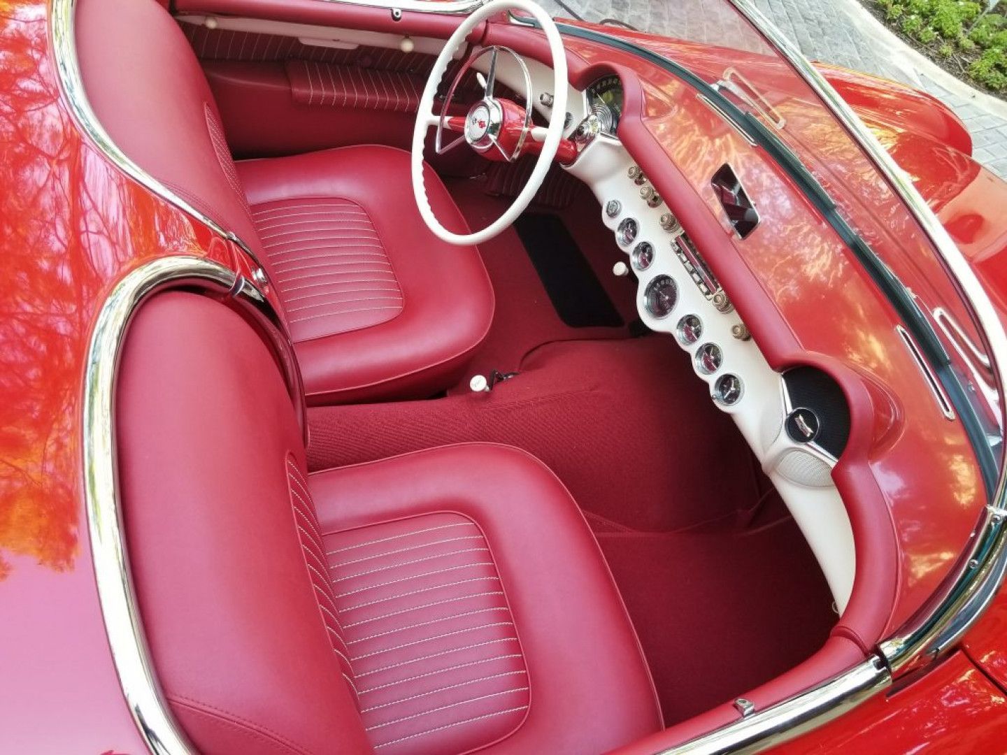 a red car with red seats and a white steering wheel