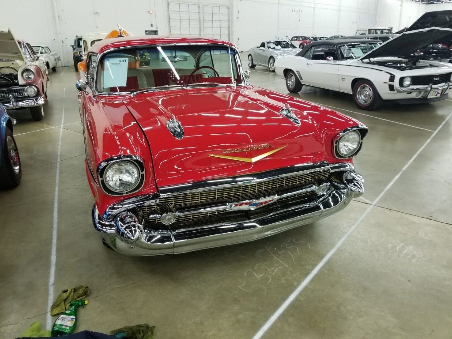 a red chevrolet is parked in a garage