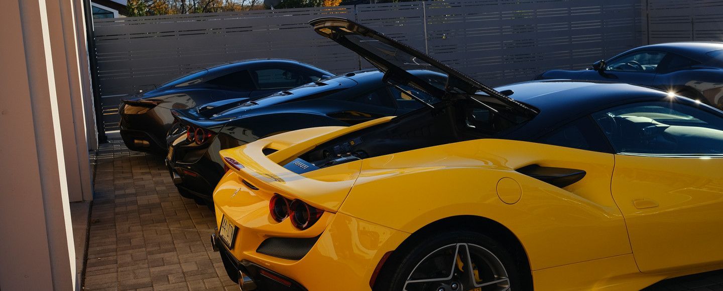 a yellow ferrari is parked next to a black ferrari