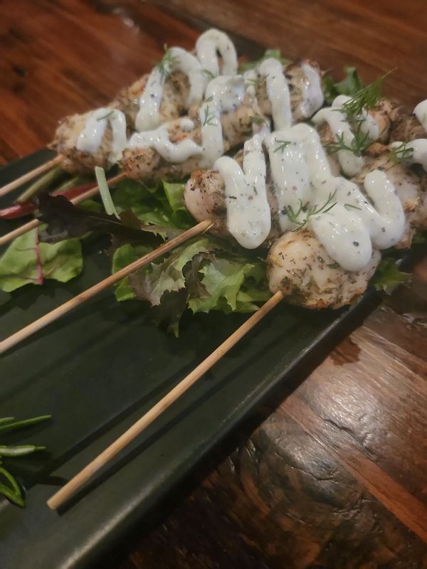 chicken skewers with Greek seasoning and topped with tzatziki sauce