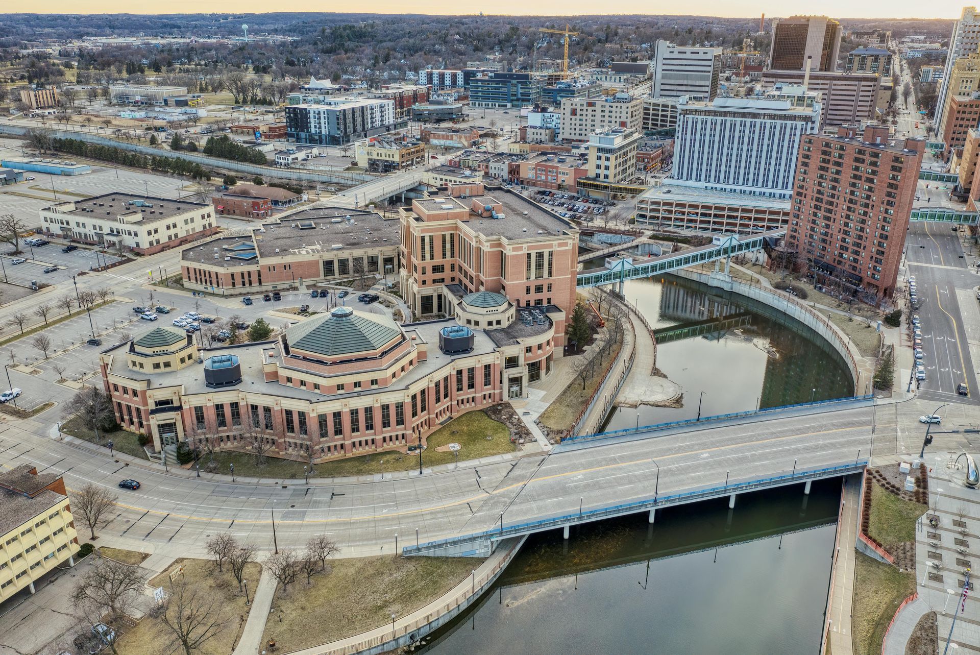 An aerial view of a city with a bridge over a river.