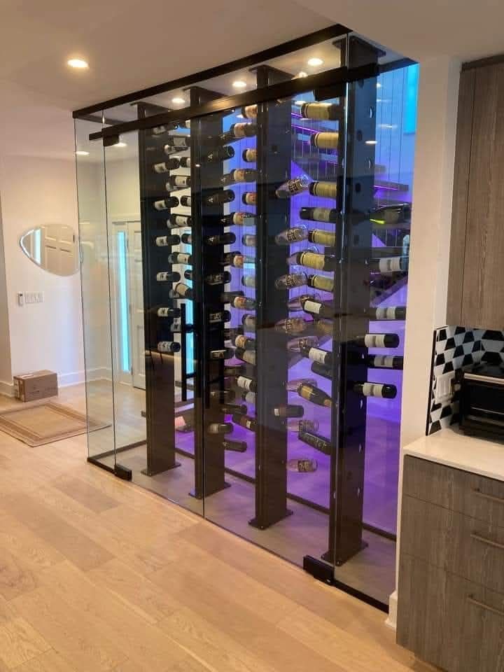 Blue house with red door and brick accents, SUV in driveway, basketball hoop.