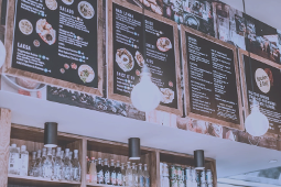 A restaurant with a lot of menus hanging from the ceiling.