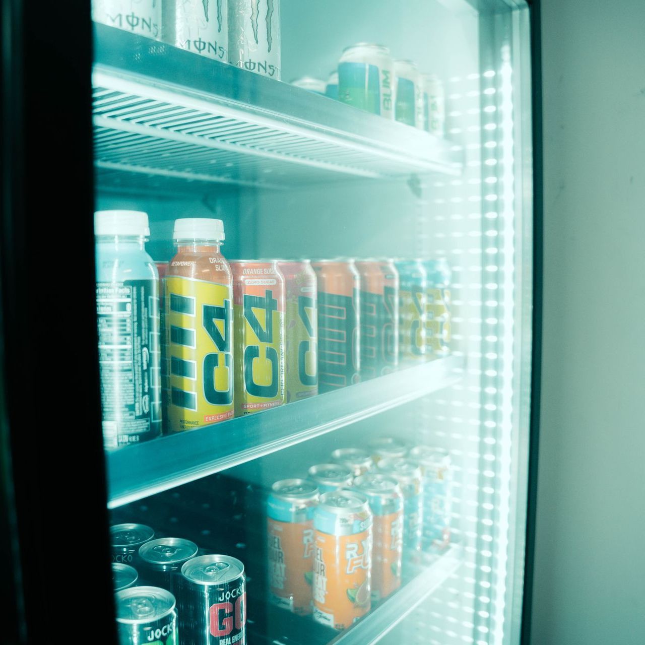 A refrigerator filled with cans and bottles including one that says dc