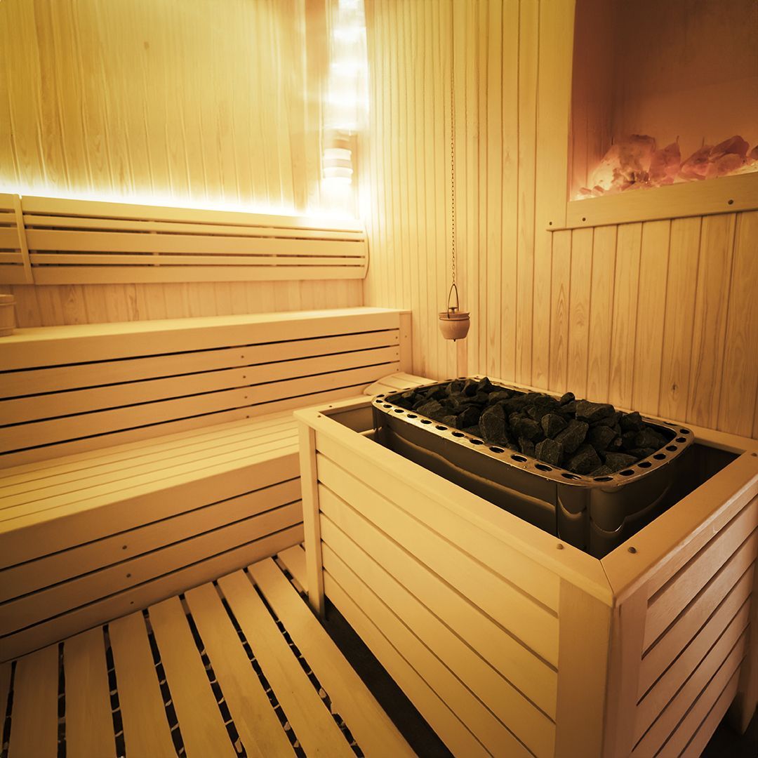 A wooden sauna with a heater in the middle