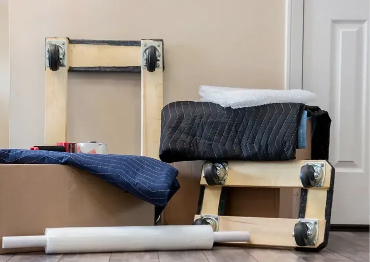 A bunch of moving supplies are sitting on the floor in a room.