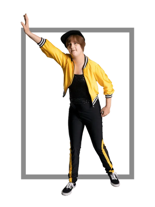 Person in yellow jacket and black pants, cap, poses with arm raised within a gray frame.