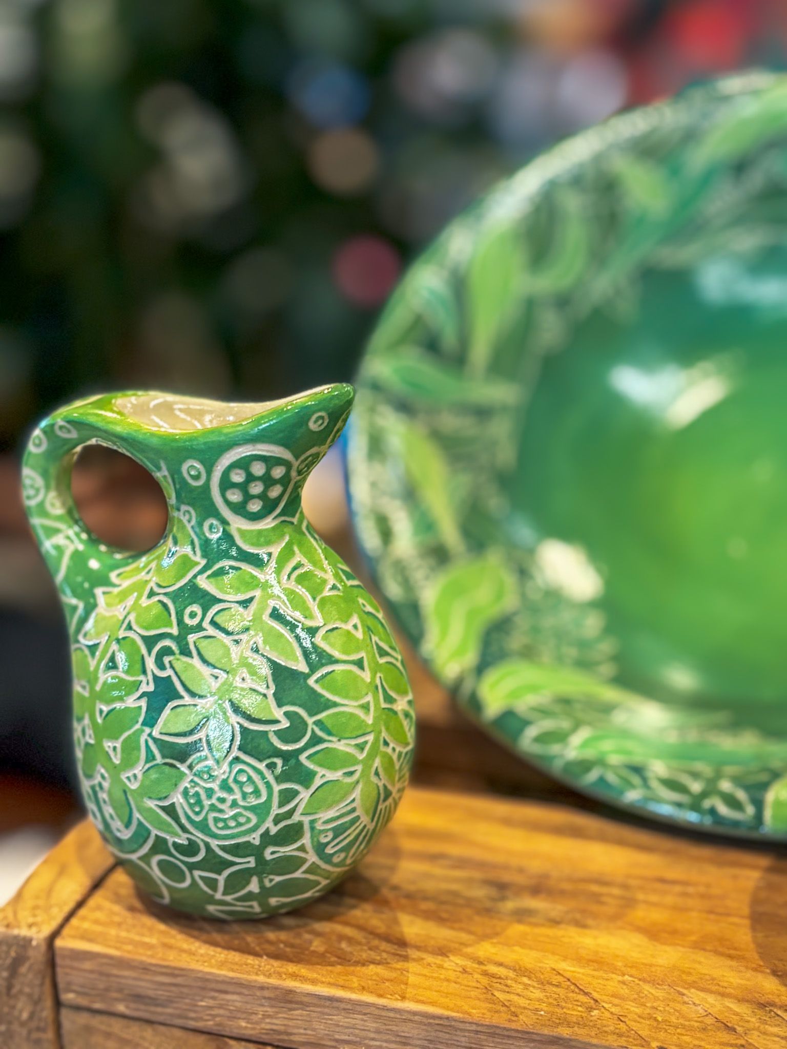 Ruined stone sculptures and steps with a green jug in a jungle setting.