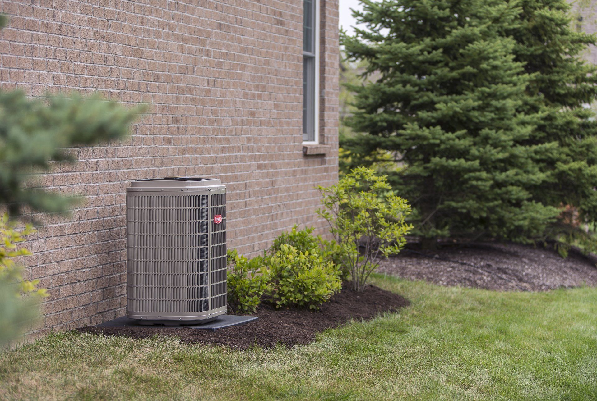 Bryant Airconditioner Near Brick Wall House — House Springs, MO — Midwest Mechanical
