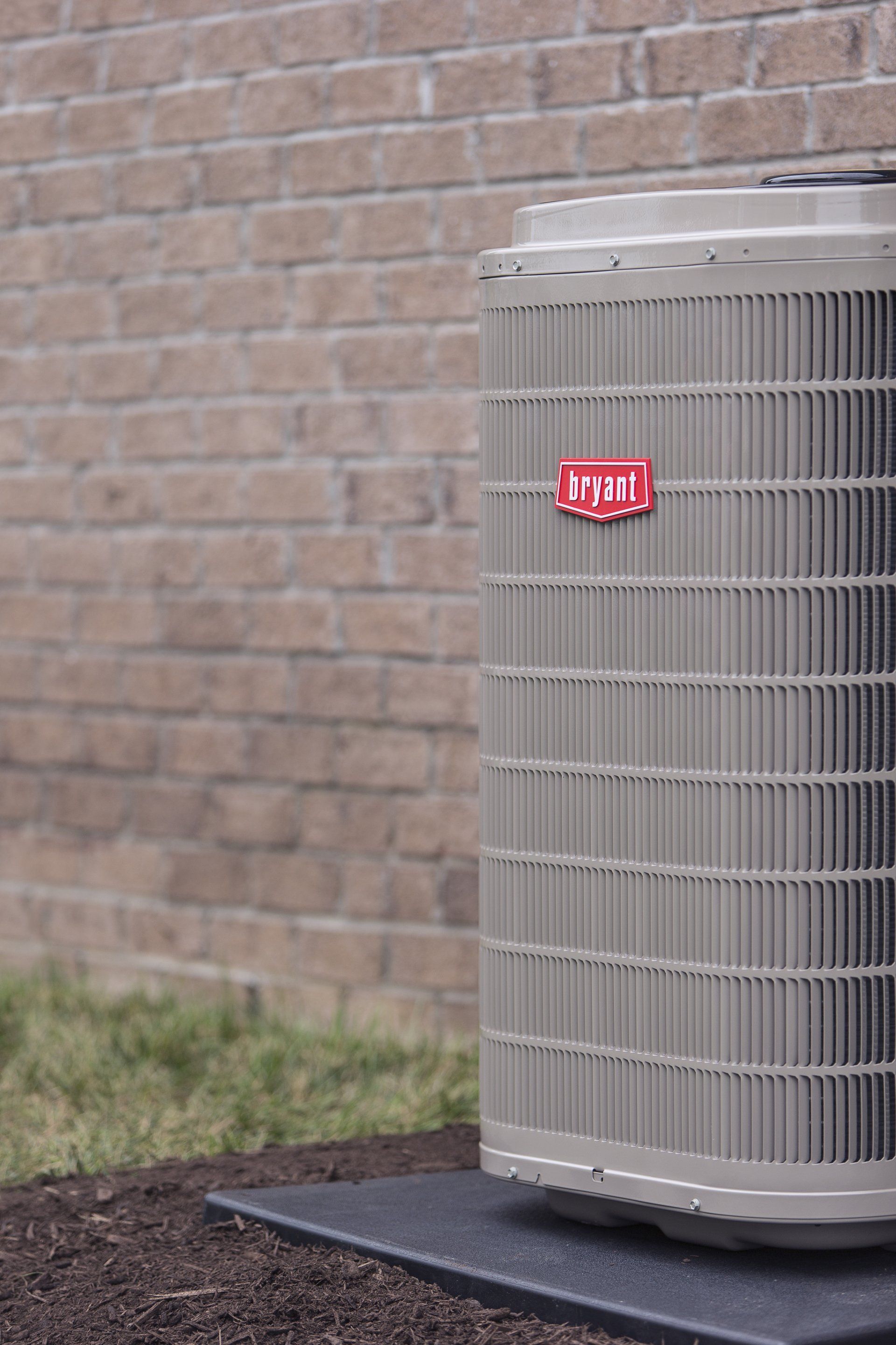 Bryant Airconditioner Near Brick Wall — House Springs, MO — Midwest Mechanical
