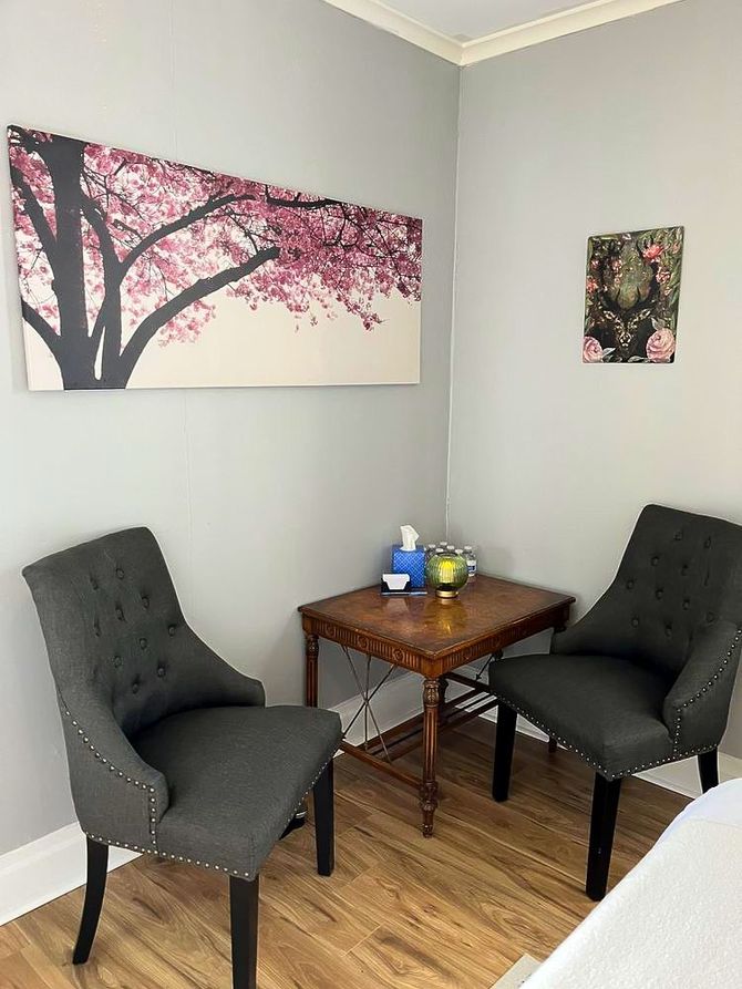 There are two chairs and a table in the room.