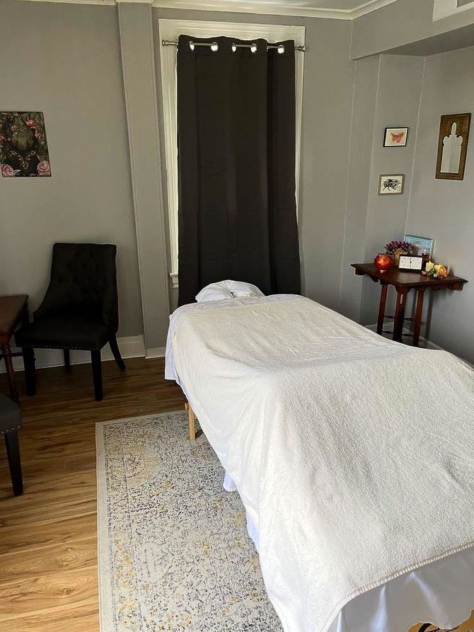 There is a massage table in the middle of the room.